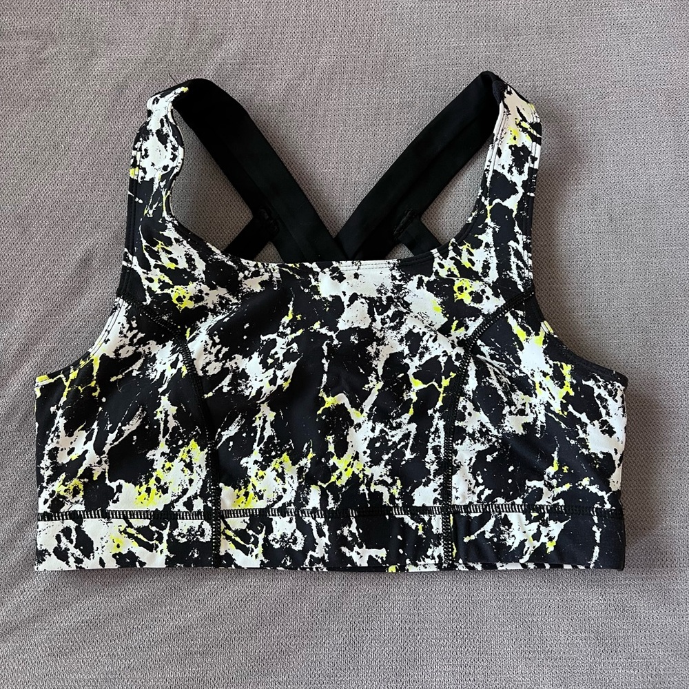 Torrid black, white, and neon yellow paint splatter sports bra